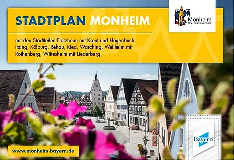 Titelseite des Stadtplans der Stadt Monheim, mit dem gleichnamigen Titel auf gelbem Hintergrund, das Wort Stadtplan in blau, das Wort Monheim in weiß. Darunter Angabe aller dazugehöriger Stadtteile von Monheim in schwarzer Schrift und rechts oben im Eck das Logo der Stadt Monheim. Auf dem darunterliegenden Foto der Blick auf historische Fachwerkhäuser in der Monheimer Innenstadt und im Vordergrund unscharf blühende pinke Blumen.